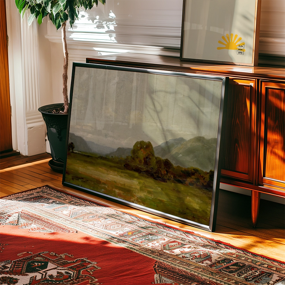 Framed landscape painting propped against a wooden cabinet, with a plant and patterned rug in the background.