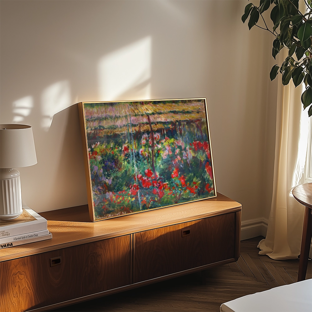 Framed painting of colorful flowers displayed on a wooden table next to a lamp and shelf in a well-lit room.
