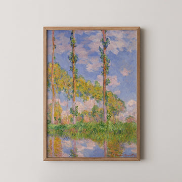 Framed painting of trees against a blue sky with fluffy clouds, reflecting in a body of water.