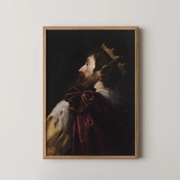 Portrait of a king in profile wearing a crown and luxurious apparel, framed in wood.