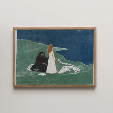 Painting of a woman in a white dress standing beside a black bear-like figure on a green landscape, with a blue sky and water in the background, framed in wood.