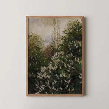 A framed painting of a green and white floral landscape with trees, displayed on a light wall.