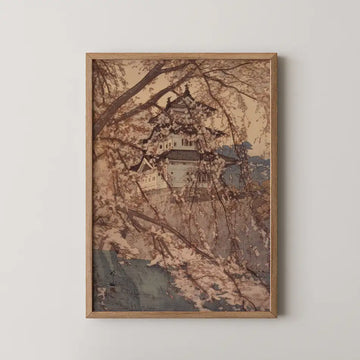 A framed painting depicting a traditional building surrounded by cherry blossom trees against a soft, muted background.