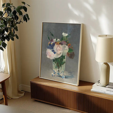 Painting of a bouquet of flowers in a glass vase, displayed in a stylish interior setting with natural light.