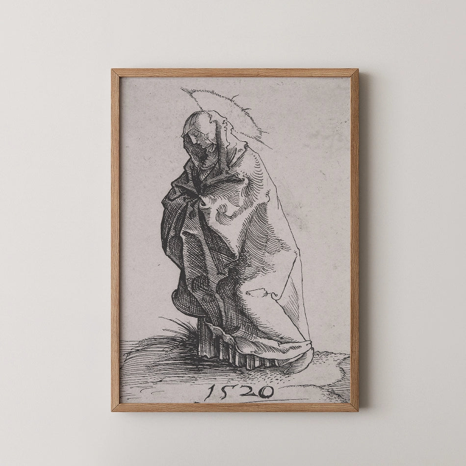 A framed black and white artwork depicting a draped figure with a halo, dated 1520, displayed on a white wall.