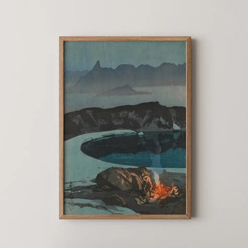 Framed painting of a serene landscape featuring a campfire by a body of water, surrounded by dark mountains and a twilight sky.