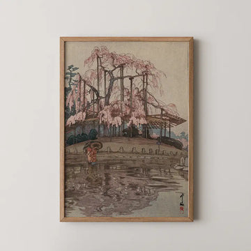 Hiroshi Yoshida woodblock print of a woman with an umbrella beside a pond as rain falls on a great blossoming cherry tree.