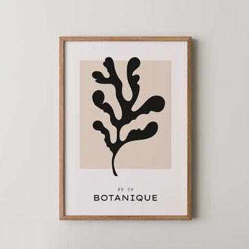 Elegant abstract botanical art print featuring a black seaweed silhouette against a soft beige background, framed by a minimalist white border with bold typography reading 'BOTANIQUE.'