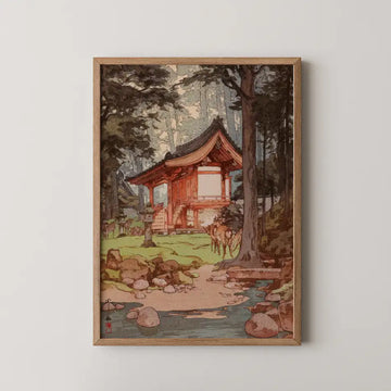 Hiroshi Yoshida woodblock print of a red shrine building in a forest clearing, with deer grazing beside a stream in the foreground.