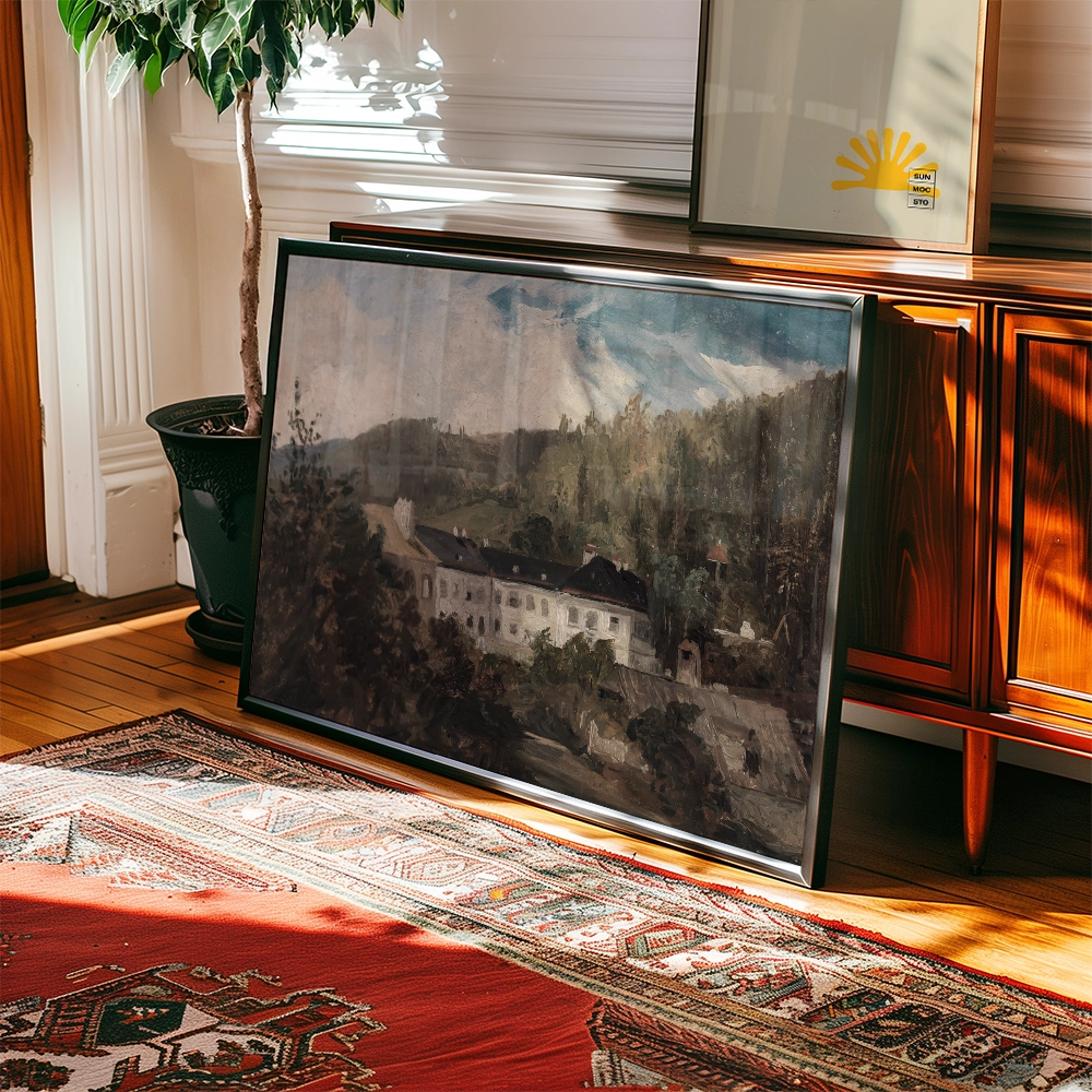 Framed painting of a serene landscape featuring mountains, trees, and a historic building, displayed on a wooden floor next to a decorative rug and a houseplant.