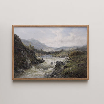 Framed landscape painting of a river flowing through rolling hills and mountains under a cloudy sky.