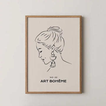 Elegant minimalist portrait art print featuring a woman in profile wearing a bohemian earring with tassel on a soft beige backdrop, framed in wood, part of the Line Art Collection."