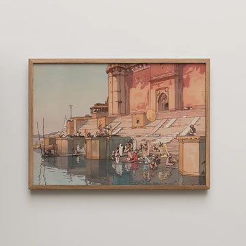 Painting of a vibrant scene by the river, depicting people engaged in daily activities near a historical building, framed in natural wood.