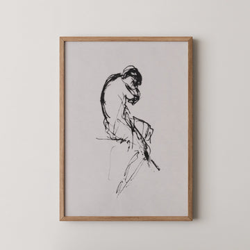 Framed black and white sketch of a seated figure, displayed against a neutral background.