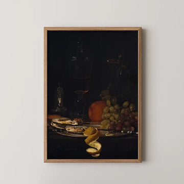 Still life painting featuring a glass of dark liquid, fruits including an orange and grapes, and a decorative plate with citrus peels, framed in wood.