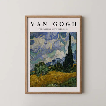 Van Gogh poster featuring "Wheatfield with Cypresses" in a wooden frame against a light wall.