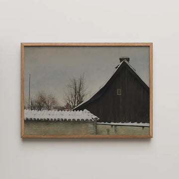 Painting of a snow-covered roof and dark wooden barn against a muted sky, framed in light wood.
