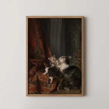 Painting of three kittens next to a red draped fabric, framed in wood.
